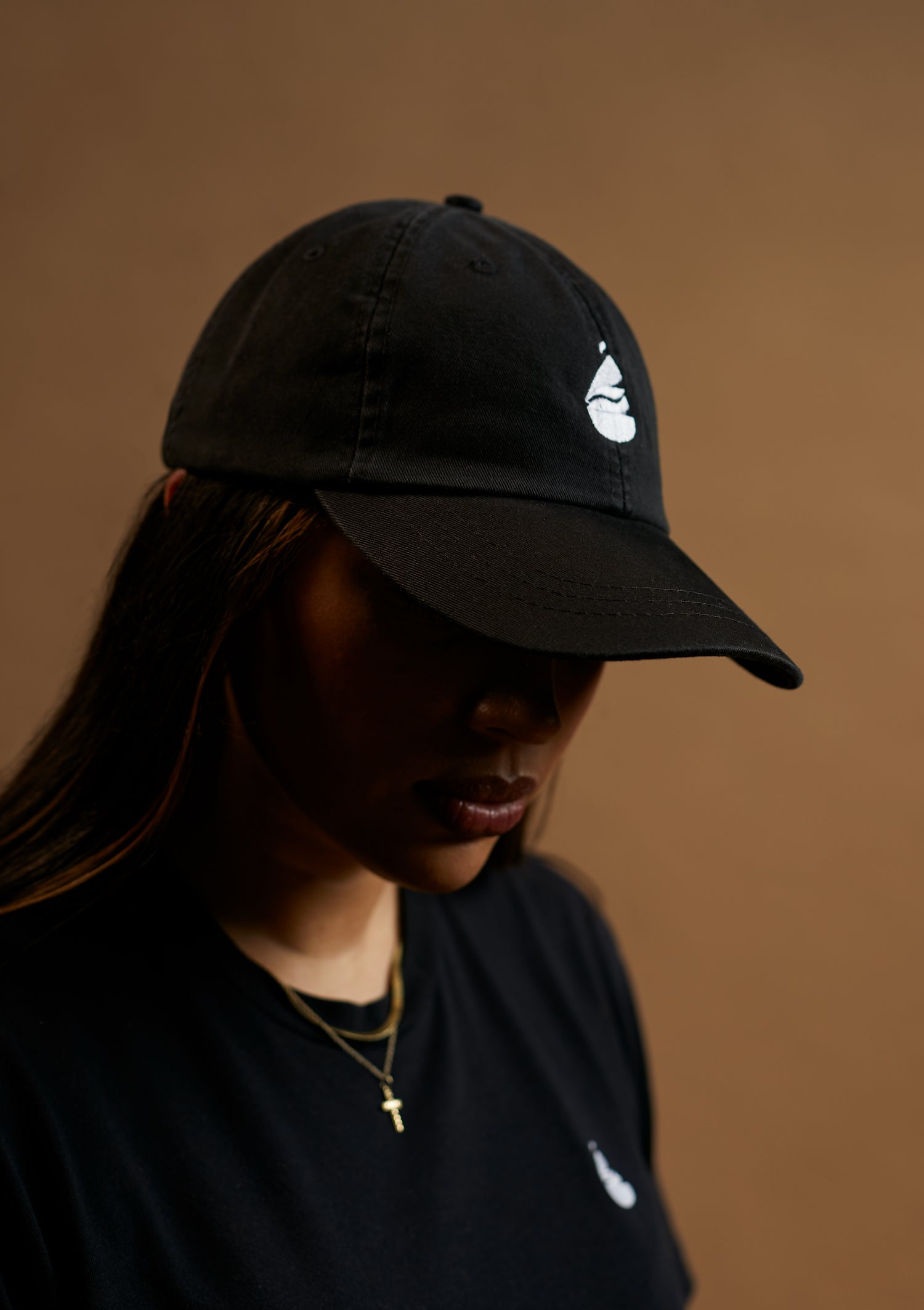 black dad hat with white embroidery logo